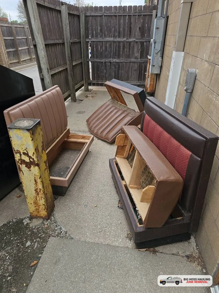 Before: old restaurant booths piled in a narrow alley
