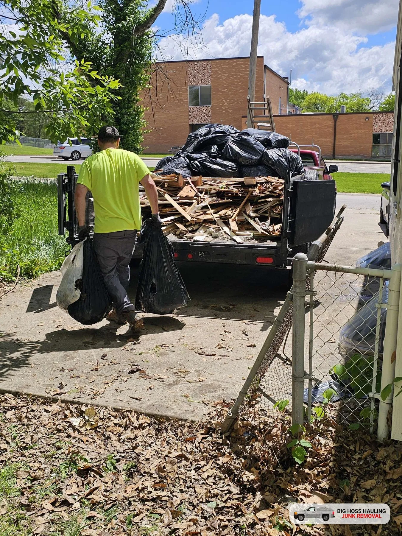 Crew member carrying bags of junk to the trailer