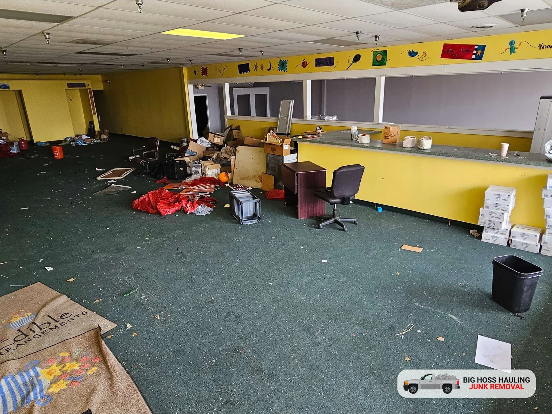 Before: an office full of boxes, chairs and trash
