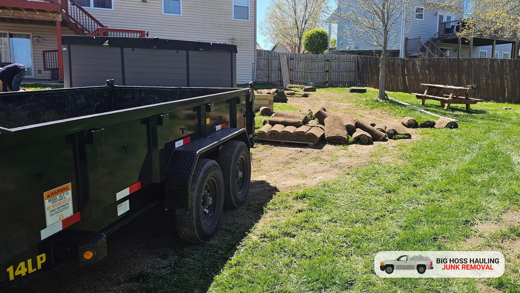 A neat green back yard with the Big Hoss trailer