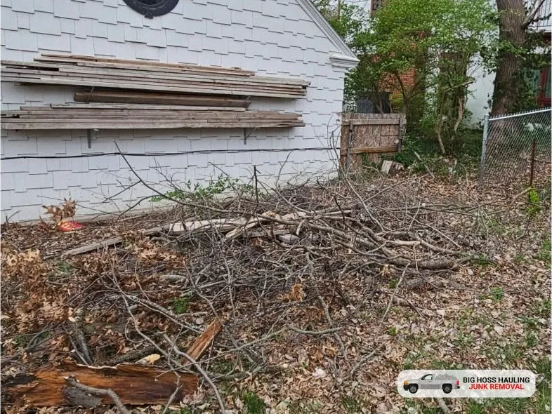 Before: a pile of branches beside a white house